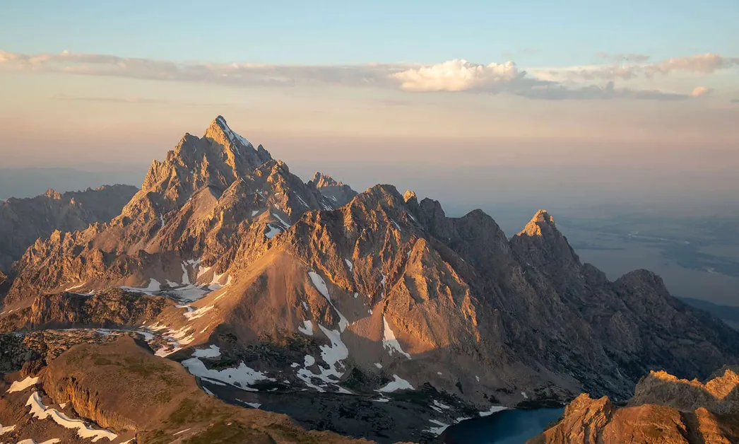 The Grand Teton summit ridge in warm alpenglow