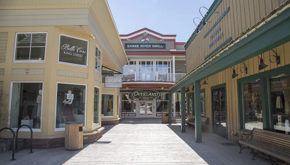 Storefronts along the downtown Jackson boardwalk on a sunny day