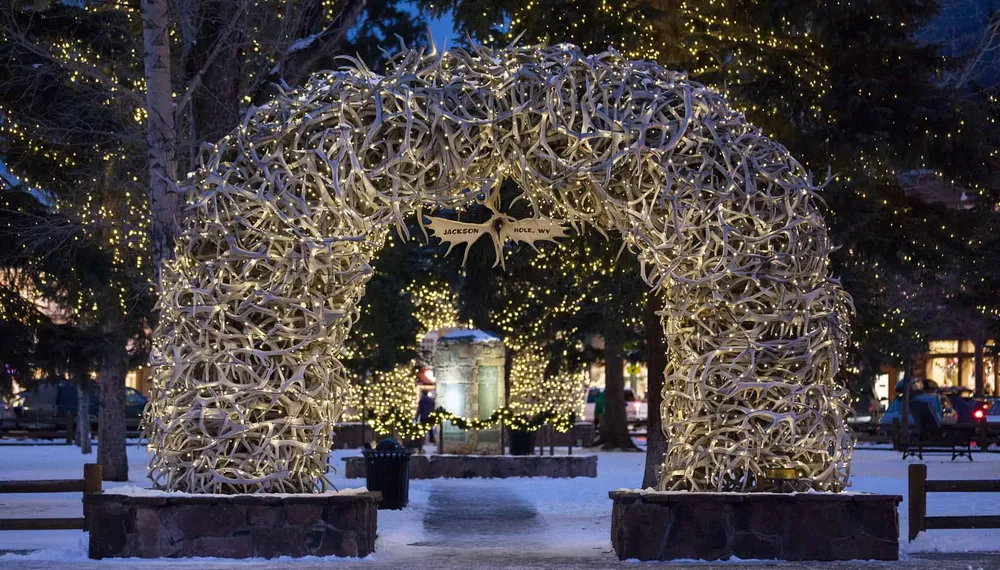 The elk-antler arch on Jackson Town Square, lit at night in the snow